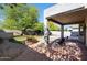 Outdoor patio with brick flooring, seating and a manicured lawn with mature shade trees in the backyard at 7336 E Overlook Dr, Scottsdale, AZ 85255