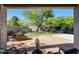 Covered patio overlooking the backyard featuring a brick planter and mature trees at 7336 E Overlook Dr, Scottsdale, AZ 85255