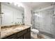 Bathroom with marble shower, granite countertop, and framed mirror at 7336 E Overlook Dr, Scottsdale, AZ 85255