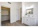 Bathroom featuring a vanity with marble countertops, neutral walls, wood-look floors and an open closet at 7336 E Overlook Dr, Scottsdale, AZ 85255