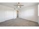 Well-lit bedroom with a ceiling fan and closet offering ample storage solutions for organized living at 7336 E Overlook Dr, Scottsdale, AZ 85255