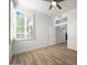 Empty bedroom featuring wood-look tile flooring and large windows with wooden shutters at 7336 E Overlook Dr, Scottsdale, AZ 85255
