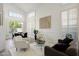 Open-concept living room with large windows, shutters, and wood-look tile flooring at 7336 E Overlook Dr, Scottsdale, AZ 85255