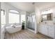 Bright bathroom with a glass shower, soaking tub, double vanities and modern fixtures at 7336 E Overlook Dr, Scottsdale, AZ 85255