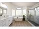 Modern bathroom with soaking tub, glass-enclosed shower, double vanity and wood-look tile flooring at 7336 E Overlook Dr, Scottsdale, AZ 85255