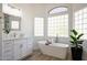 Bathroom featuring a freestanding tub, marble countertops, and bright lighting at 7336 E Overlook Dr, Scottsdale, AZ 85255
