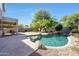 Backyard oasis featuring a private pool with waterfall, mature trees, and well-maintained landscaping at 7336 E Overlook Dr, Scottsdale, AZ 85255