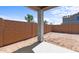 View of backyard showing an empty, enclosed space ready for landscaping or customization with a covered patio at 7643 W Park St, Laveen, AZ 85339