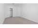 Simple bedroom with neutral carpet, closet space, and a well-lit interior at 7643 W Park St, Laveen, AZ 85339