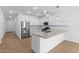 Modern kitchen featuring white cabinets, quartz countertops, stainless steel appliances and pendant lighting at 7643 W Park St, Laveen, AZ 85339