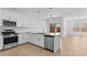 Bright kitchen featuring white cabinets, quartz countertops, and stainless steel appliances at 7643 W Park St, Laveen, AZ 85339