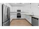 Modern kitchen featuring white cabinets, quartz countertops, and stainless steel appliances at 7643 W Park St, Laveen, AZ 85339