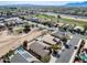 An aerial view shows houses with pools in a neighborhood close to a golf course and a highway at 809 S 120Th Ave, Avondale, AZ 85323