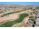 Aerial view of a Primary-planned community with houses, golf course, and mountain views at 809 S 120Th Ave, Avondale, AZ 85323