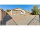 View of back of home with a brick and gravel area, along with screened in patio at 809 S 120Th Ave, Avondale, AZ 85323