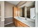 Bathroom featuring double sinks, a vanity, and a tiled shower at 809 S 120Th Ave, Avondale, AZ 85323