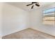 Bright bedroom with carpet, a window offering natural light, and a ceiling fan at 809 S 120Th Ave, Avondale, AZ 85323