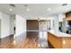 View of living room and kitchen with hardwood floors, stainless steel appliances, and granite countertops at 809 S 120Th Ave, Avondale, AZ 85323