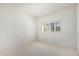 This bedroom is brightly lit and features a neutral color palette and large window with shutters at 9204 N 106Th Way, Scottsdale, AZ 85258