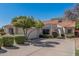 Beautiful single-story home with a tile roof, green shrubs, and a two-car garage at 9204 N 106Th Way, Scottsdale, AZ 85258