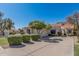 Charming home featuring a tile roof, mature landscaping, and a spacious driveway at 9204 N 106Th Way, Scottsdale, AZ 85258