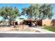 Stunning home exterior showcasing lush landscaping, mature trees, and a welcoming stone entrance at 9204 N 106Th Way, Scottsdale, AZ 85258