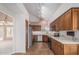 Well-lit kitchen featuring stainless appliances, wood cabinetry, and ample counter space at 9204 N 106Th Way, Scottsdale, AZ 85258
