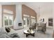 Staged living room showcasing a fireplace, high ceilings, and ample natural light at 9204 N 106Th Way, Scottsdale, AZ 85258
