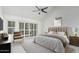 This bedroom features a neutral color palette, vaulted ceiling and ample natural light from sliding glass doors at 9204 N 106Th Way, Scottsdale, AZ 85258