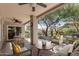 Covered patio with comfortable seating and a view of the serene, landscaped backyard at 9204 N 106Th Way, Scottsdale, AZ 85258