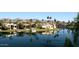 Scenic waterfront view featuring elegant homes, lush palm trees, and calm water reflections at 9204 N 106Th Way, Scottsdale, AZ 85258