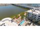 Aerial view showing a community pool and outdoor lounging area on the waterfront beneath a bridge with vehicle traffic at 945 E Playa Del Norte Dr # 1003, Tempe, AZ 85288