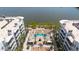 Aerial view shows a pool and waterfront between two modern apartment buildings with balconies and rooftop AC units at 945 E Playa Del Norte Dr # 1003, Tempe, AZ 85288