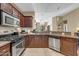 Modern kitchen with stainless steel appliances, dark cabinetry, and a breakfast bar at 945 E Playa Del Norte Dr # 1003, Tempe, AZ 85288
