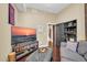 Cozy living room features a plush ottoman, TV, and curated decor for comfortable, stylish living at 945 E Playa Del Norte Dr # 1003, Tempe, AZ 85288