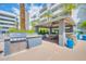 Outdoor kitchen and dining area featuring a gas grill, granite countertops, and covered seating for entertaining at 945 E Playa Del Norte Dr # 1003, Tempe, AZ 85288