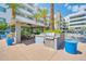 Outdoor kitchen area with a built-in grill, table, chairs, and covered bar seating at 945 E Playa Del Norte Dr # 1003, Tempe, AZ 85288
