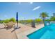 A community pool with an adjacent lake provides lounge chairs, tables, and shade umbrellas at 945 E Playa Del Norte Dr # 1003, Tempe, AZ 85288
