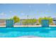 A community swimming pool flows into a lake with small waterfalls along the retaining wall at 945 E Playa Del Norte Dr # 1003, Tempe, AZ 85288