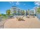Community pool and dining area with lounge chairs and dining tables located near a lake at 945 E Playa Del Norte Dr # 1003, Tempe, AZ 85288