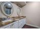 Bathroom showcasing dual sinks, framed mirrors, and granite countertops at 9847 E Michigan Ave, Sun Lakes, AZ 85248