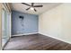 Bedroom featuring dark floors, ceiling fan, and sliding glass doors at 9847 E Michigan Ave, Sun Lakes, AZ 85248