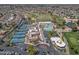 An aerial photograph highlights the community's tennis courts, pool, manicured grounds, and ample parking at 9847 E Michigan Ave, Sun Lakes, AZ 85248