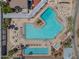 Aerial view of a large community pool area featuring lounge chairs and meticulously landscaped surroundings at 9847 E Michigan Ave, Sun Lakes, AZ 85248