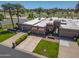 Aerial of a well-maintained single-story home with a three-car garage, pristine lawn, and mature landscaping at 9847 E Michigan Ave, Sun Lakes, AZ 85248