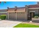 Close up of a lovely single-story home featuring an attached two-car garage with tile roofing, and manicured landscaping at 9847 E Michigan Ave, Sun Lakes, AZ 85248