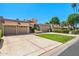 Attractive single-story home with a long driveway, well-manicured lawn, a three-car garage, and Southwestern style architecture at 9847 E Michigan Ave, Sun Lakes, AZ 85248