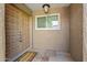 Inviting front entryway featuring a stylish door, decorative welcome mat, and exterior lighting at 9847 E Michigan Ave, Sun Lakes, AZ 85248