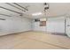 Spacious garage with painted floor and built-in cabinets at 9847 E Michigan Ave, Sun Lakes, AZ 85248