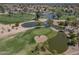 Scenic aerial view of a lush golf course with ponds and mature trees in a well-maintained community at 9847 E Michigan Ave, Sun Lakes, AZ 85248